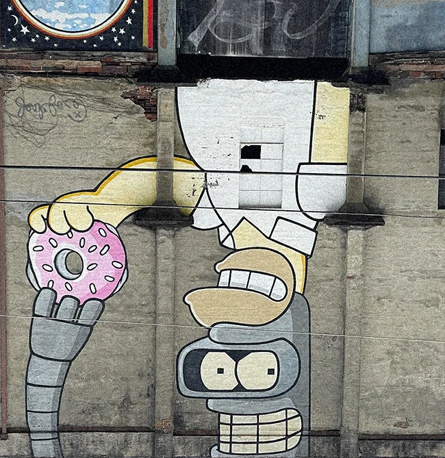 Asheville graffiti of Bender from Futurama and Homer Simpson grabbing a donut