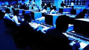 chaotic office floor with agents on computers