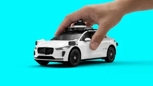 Waymo robotaxi being driven by a hand