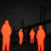 moody editorial image of San Francisco Bay Bridge with glowing orange people outlined